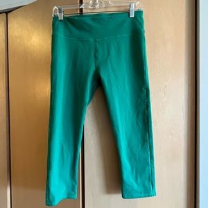 Fabletics green capri leggings. Keyhole cutouts on side.